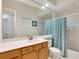Clean bathroom with light wood vanity and teal shower curtain at 6747 Coyote Ridge Ct, Bradenton, FL 34201