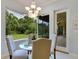 Kitchen breakfast nook with glass-top table and view of backyard at 6747 Coyote Ridge Ct, Bradenton, FL 34201