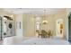 Formal dining room with chandelier and views into other rooms at 6747 Coyote Ridge Ct, Bradenton, FL 34201