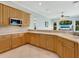 Modern kitchen with light wood cabinets, stainless steel appliances, and a breakfast bar at 6747 Coyote Ridge Ct, Bradenton, FL 34201