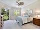Spacious bedroom with a ceiling fan, large window, and plenty of natural light at 6747 Coyote Ridge Ct, Bradenton, FL 34201