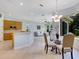 Kitchen features light wood cabinets, breakfast nook, and view into Gathering room at 6747 Coyote Ridge Ct, Bradenton, FL 34201