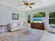 Bright living room with large windows, comfortable seating, and a glass coffee table at 6747 Coyote Ridge Ct, Bradenton, FL 34201