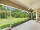 Relaxing screened porch with ceiling fan and view of backyard at 6747 Coyote Ridge Ct, Bradenton, FL 34201