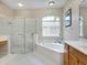 Elegant bathroom with a corner soaking tub, glass shower, and dual sinks at 6747 Coyote Ridge Ct, Bradenton, FL 34201
