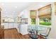 Bright kitchen with white cabinets and a cozy eat-in area at 2310 Lark Ln # 22, Sarasota, FL 34231