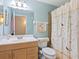 Bathroom with light wood vanity, shower, and bird-themed curtain at 5026 Water Oak Dr # 119, Bradenton, FL 34207