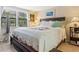 Spacious main bedroom with king-size bed and window with blinds at 5026 Water Oak Dr # 119, Bradenton, FL 34207