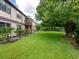 Large grassy backyard with mature trees and landscaping at 5026 Water Oak Dr # 119, Bradenton, FL 34207