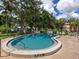 Kidney shaped community pool with surrounding patio at 5026 Water Oak Dr # 119, Bradenton, FL 34207
