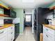 Modern kitchen with wood countertops, white cabinets, and black appliances at 5026 Water Oak Dr # 119, Bradenton, FL 34207