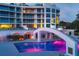 Resort-style pool and bridge at night, with building in background at 2251 Gulf Of Mexico Dr # 301, Longboat Key, FL 34228