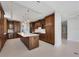 Spacious kitchen featuring an island and rich wood cabinets at 2251 Gulf Of Mexico Dr # 301, Longboat Key, FL 34228
