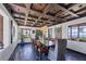 Elegant dining room with dark wood table, coffered ceiling, and ocean views at 2251 Gulf Of Mexico Dr # 301, Longboat Key, FL 34228