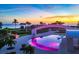 Inviting resort-style pool at sunset with ocean views at 2251 Gulf Of Mexico Dr # 301, Longboat Key, FL 34228