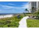Landscaped walkway to beach access with ocean views at 2251 Gulf Of Mexico Dr # 301, Longboat Key, FL 34228