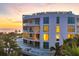 Stunning oceanfront condo building at sunset at 2251 Gulf Of Mexico Dr # 301, Longboat Key, FL 34228