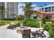 Relaxing fire pit area with comfortable seating and lush landscaping at 2251 Gulf Of Mexico Dr # 301, Longboat Key, FL 34228