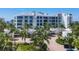 Luxury condo building with tropical landscaping at 2251 Gulf Of Mexico Dr # 301, Longboat Key, FL 34228