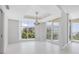 Bright dining room with large windows and elegant chandelier at 2251 Gulf Of Mexico Dr # 301, Longboat Key, FL 34228