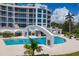 Resort-style pool with surrounding landscaping at 2251 Gulf Of Mexico Dr # 301, Longboat Key, FL 34228