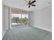 Spacious bedroom with balcony access and soft carpeting at 2251 Gulf Of Mexico Dr # 301, Longboat Key, FL 34228