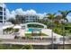 Resort-style pool with lounge chairs and lush landscaping at 2251 Gulf Of Mexico Dr # 301, Longboat Key, FL 34228