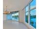 Elegant dining room with large windows and chandelier at 2251 Gulf Of Mexico Dr # 301, Longboat Key, FL 34228