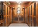 Impressive wine cellar with wooden cabinets and a checkered floor at 2251 Gulf Of Mexico Dr # 301, Longboat Key, FL 34228