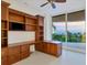 Home office with built-in wooden desk and shelving, plus ocean view at 2251 Gulf Of Mexico Dr # 301, Longboat Key, FL 34228
