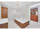 Bathroom with soaking tub and walk-in closet at 2251 Gulf Of Mexico Dr # 301, Longboat Key, FL 34228