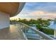 Spacious balcony overlooking lush tropical landscape and sunset at 2251 Gulf Of Mexico Dr # 301, Longboat Key, FL 34228