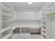 Bright, spacious storage room with custom shelving and counter at 2251 Gulf Of Mexico Dr # 301, Longboat Key, FL 34228