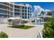 Resort-style pool with spacious deck and modern cabanas at 2251 Gulf Of Mexico Dr # 301, Longboat Key, FL 34228