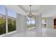 Sunlit dining area boasting a crystal chandelier and ocean views at 2251 Gulf Of Mexico Dr # 301, Longboat Key, FL 34228