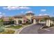 Clubhouse exterior showcasing covered entry, tile roof, and desert landscaping at 13116 Treviso Dr, Bradenton, FL 34211