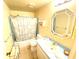 Bathroom with shower/tub combo, toilet and vanity with light blue cabinets at 2434 Fourwind St, Port Charlotte, FL 33948