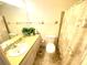 Bathroom with single sink vanity, toilet and shower/tub combo at 2434 Fourwind St, Port Charlotte, FL 33948