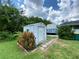 White storage shed in the backyard, providing extra storage space at 2434 Fourwind St, Port Charlotte, FL 33948