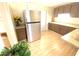 Stainless steel refrigerator and wood cabinets in kitchen at 2434 Fourwind St, Port Charlotte, FL 33948
