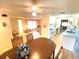 View of kitchen, dining, and living areas with light flooring at 2434 Fourwind St, Port Charlotte, FL 33948