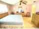 Spacious main bedroom with large bed, dresser and ceiling fan at 2434 Fourwind St, Port Charlotte, FL 33948