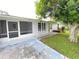 Home with screened porch and mature landscaping at 2434 Fourwind St, Port Charlotte, FL 33948