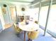 Bright dining area with round table and four chairs, features built-in shelving at 2434 Fourwind St, Port Charlotte, FL 33948