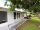 White single story home with covered entryway and mature landscaping at 2434 Fourwind St, Port Charlotte, FL 33948