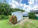 White storage shed in the backyard, providing extra storage space at 2434 Fourwind St, Port Charlotte, FL 33948