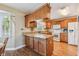 Spacious kitchen with wood cabinets, granite countertops, and modern appliances at 1914 24Th W Ave, Palmetto, FL 34221