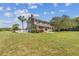 Two-story house with a side yard, white fence, and palm trees at 1914 24Th W Ave, Palmetto, FL 34221