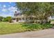Two-story house with a large tree in the front yard at 1914 24Th W Ave, Palmetto, FL 34221