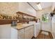 Convenient laundry room with washer, dryer, sink, and additional storage at 1914 24Th W Ave, Palmetto, FL 34221
